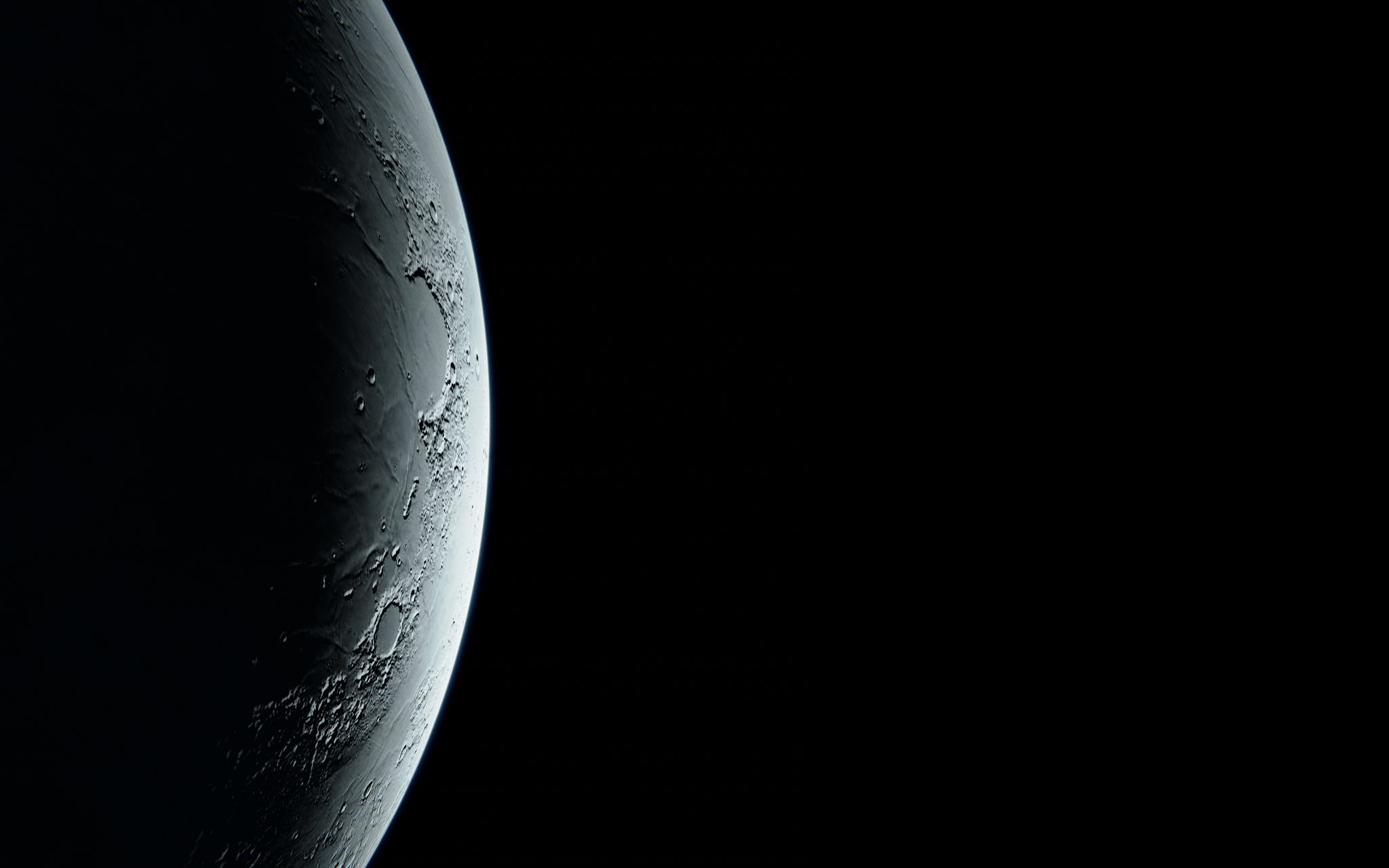 Dark side of the moon, with a hint of light coming from the right